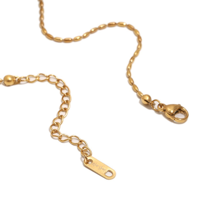a gold chain with a tag
