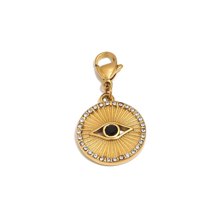 a gold pendant with a black eye and diamonds