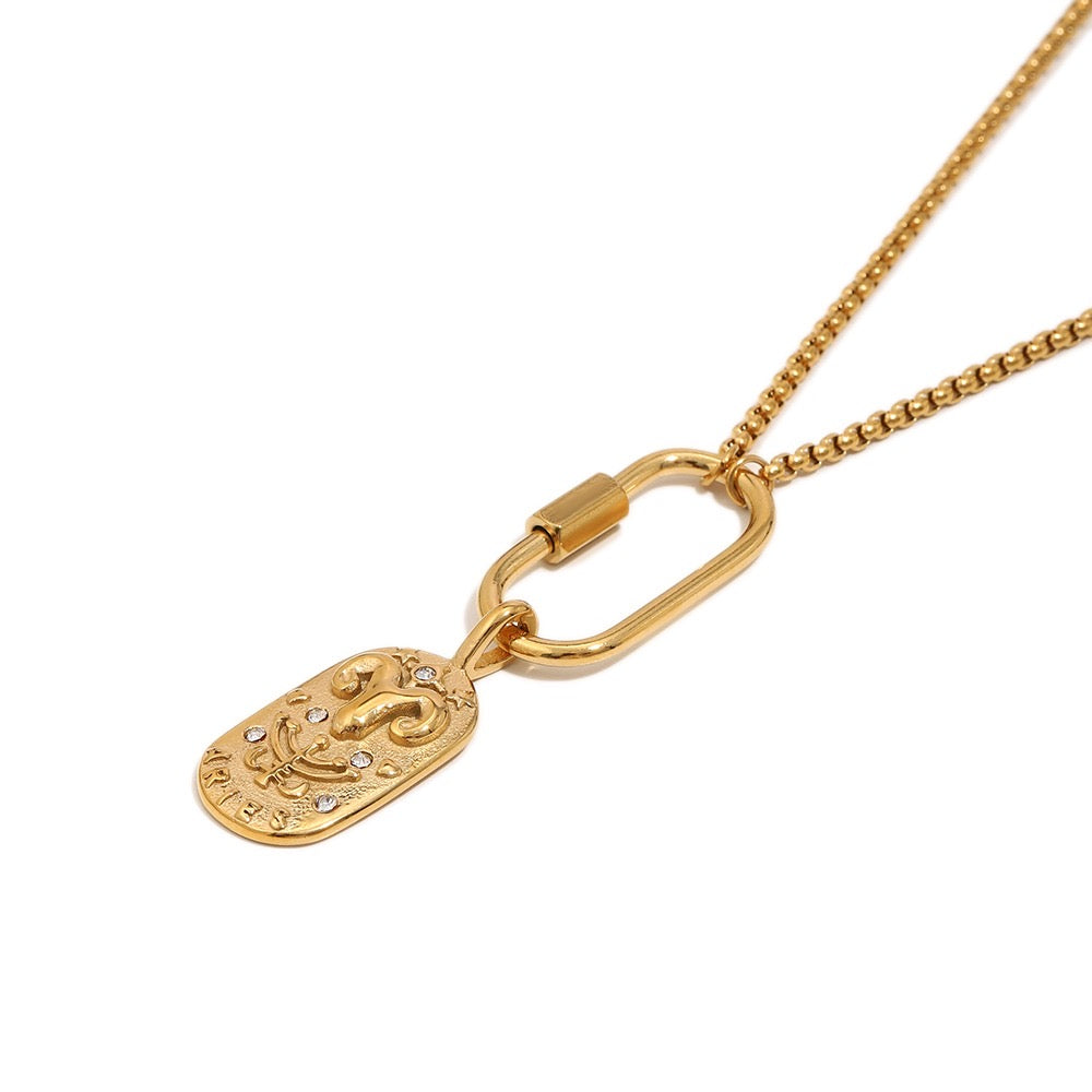 a gold necklace with a oval shaped pendant