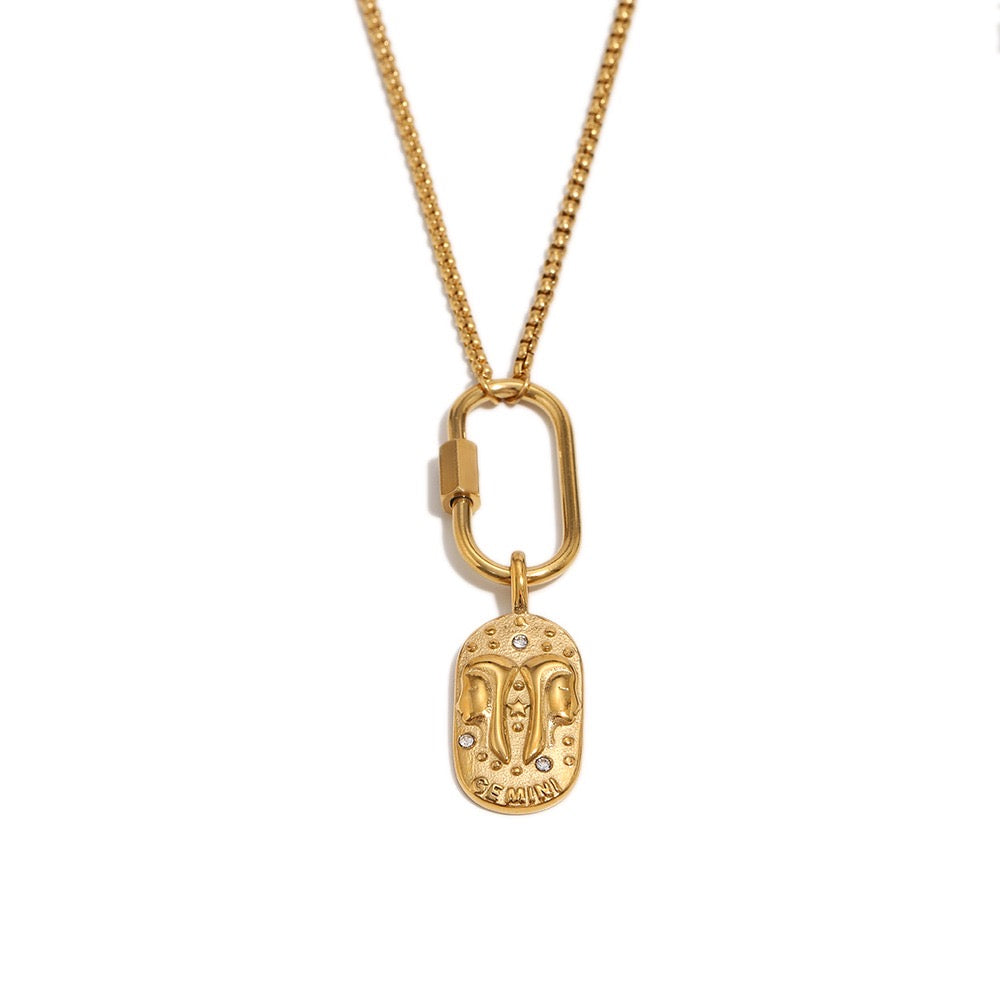 a gold necklace with a pendant
