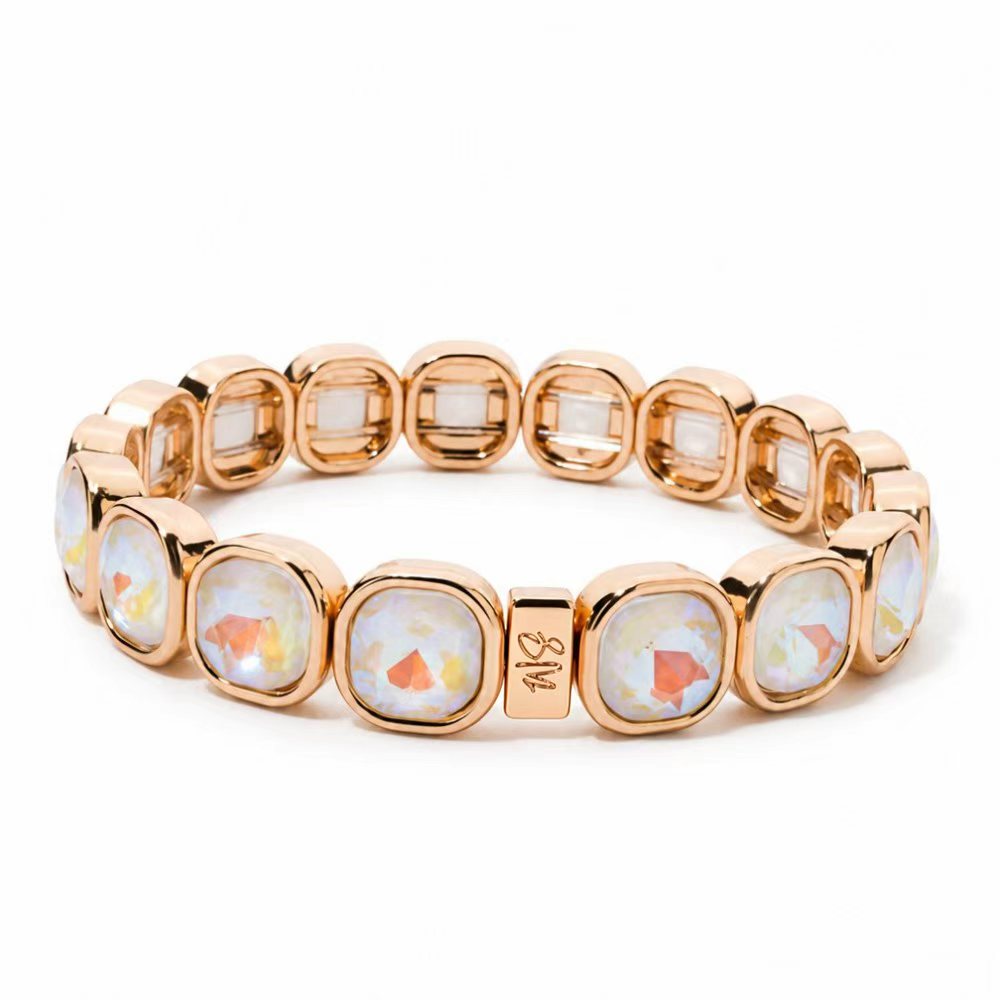 a gold bracelet with white stones