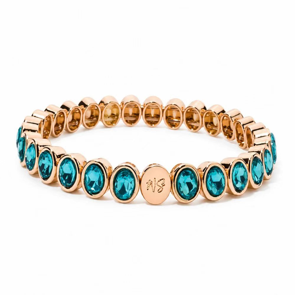a gold bracelet with blue stones