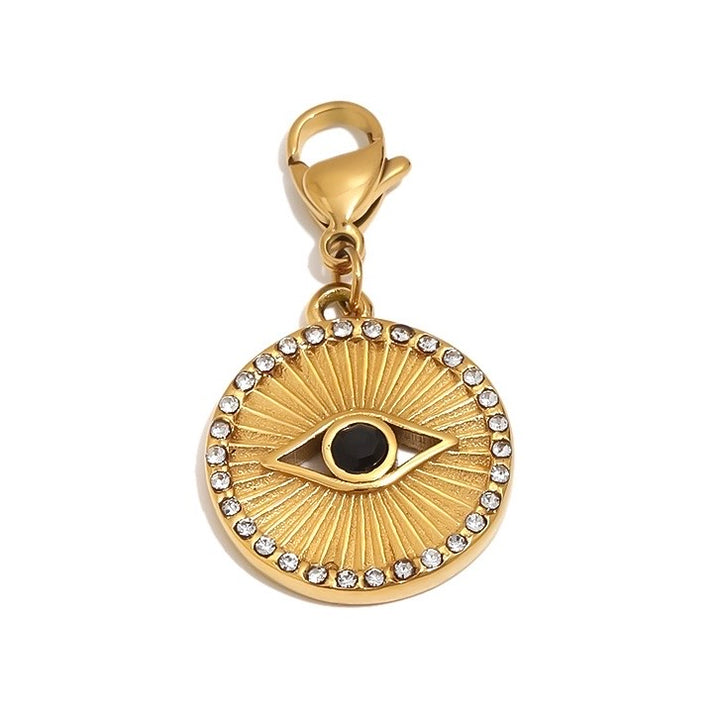 a gold pendant with a black eye