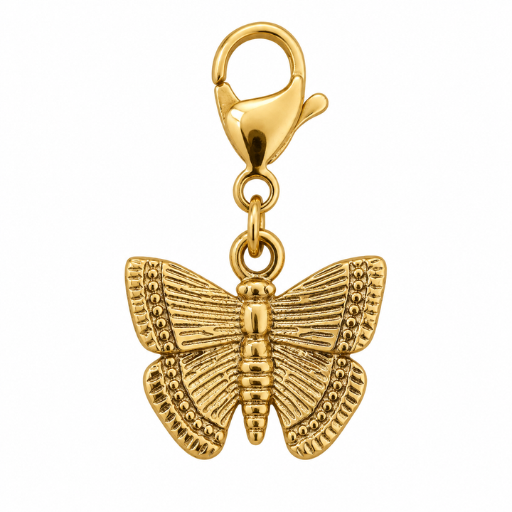 a gold butterfly charm on a white background