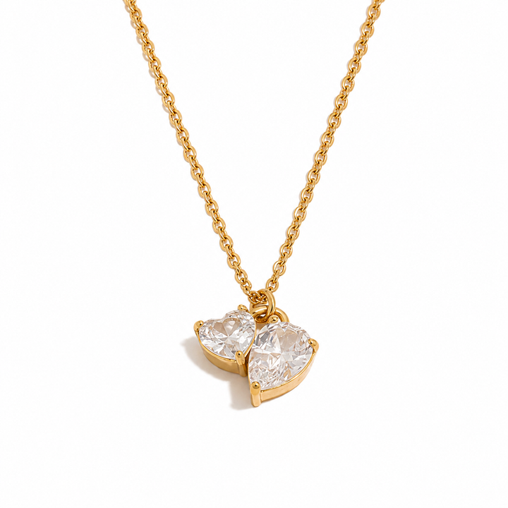 a gold chain with a heart shaped pendant