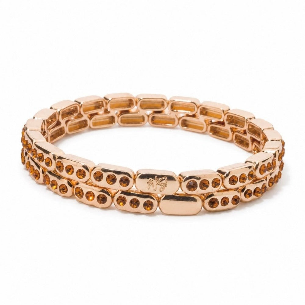a gold bracelet with orange stones