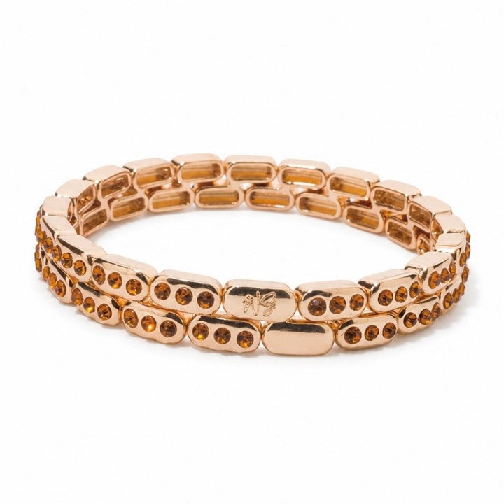 a gold bracelet with orange stones