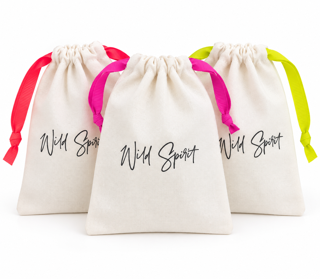 a group of white bags with pink and yellow ribbons