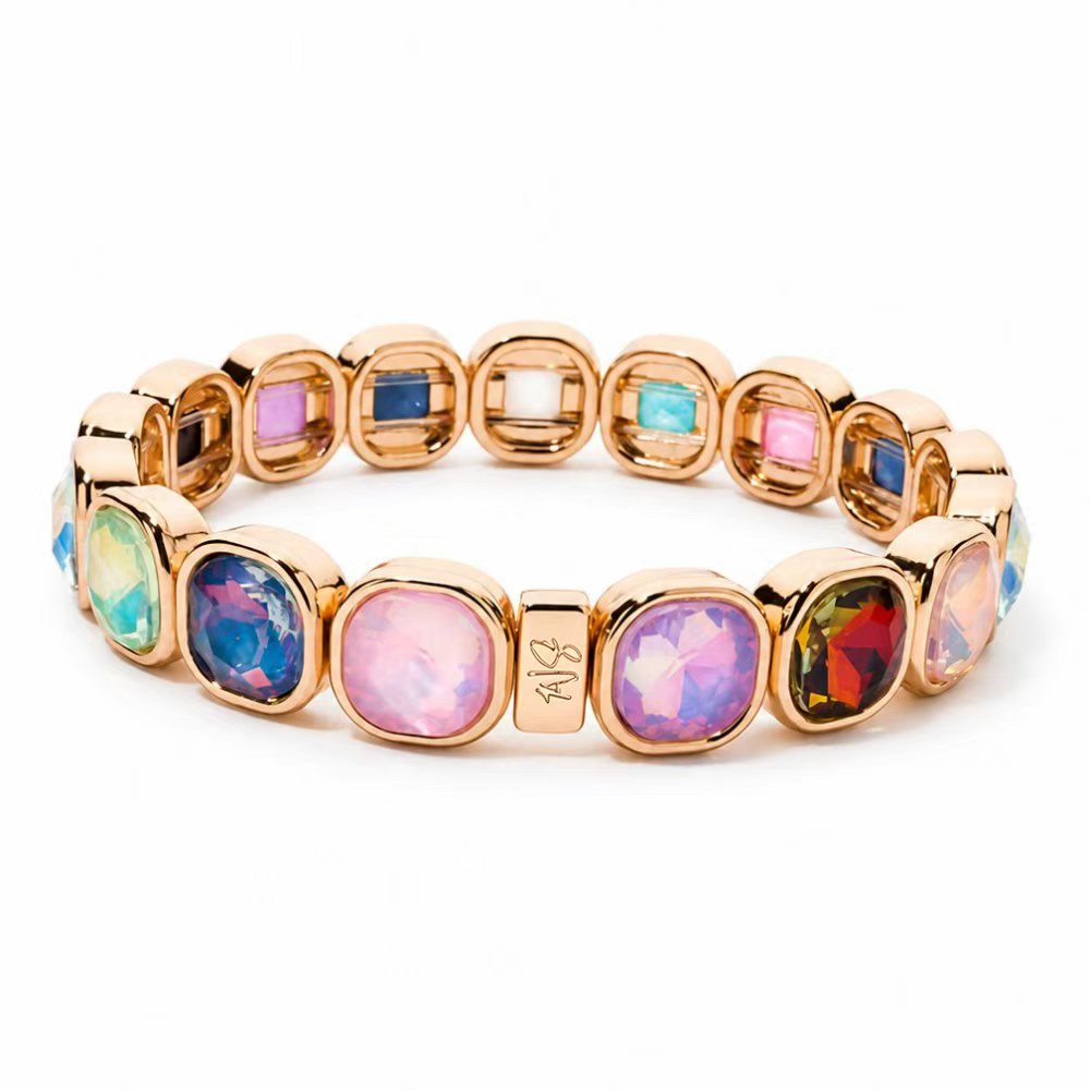 a gold bracelet with colorful stones