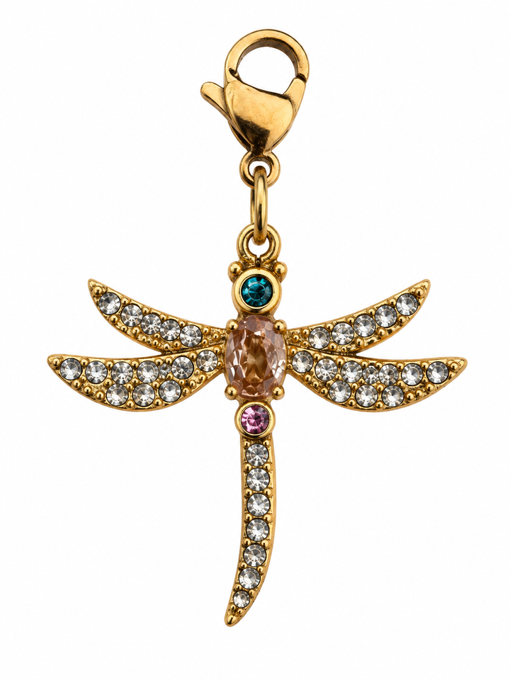 a gold dragonfly pendant with gems