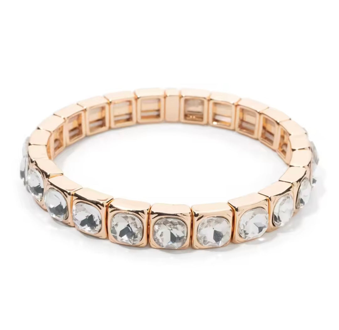 a gold and silver bracelet with diamonds