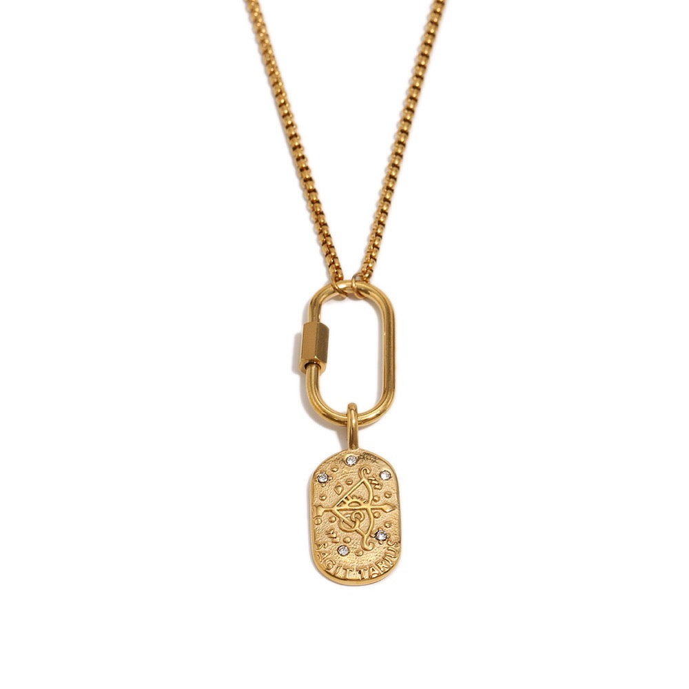 a gold necklace with a tag on it