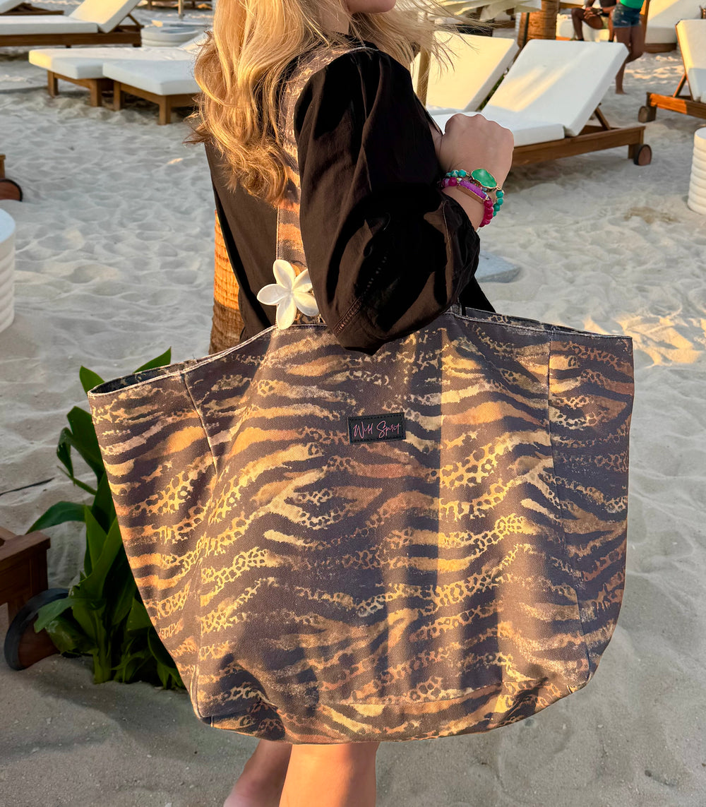 a woman carrying a bag on a beach
