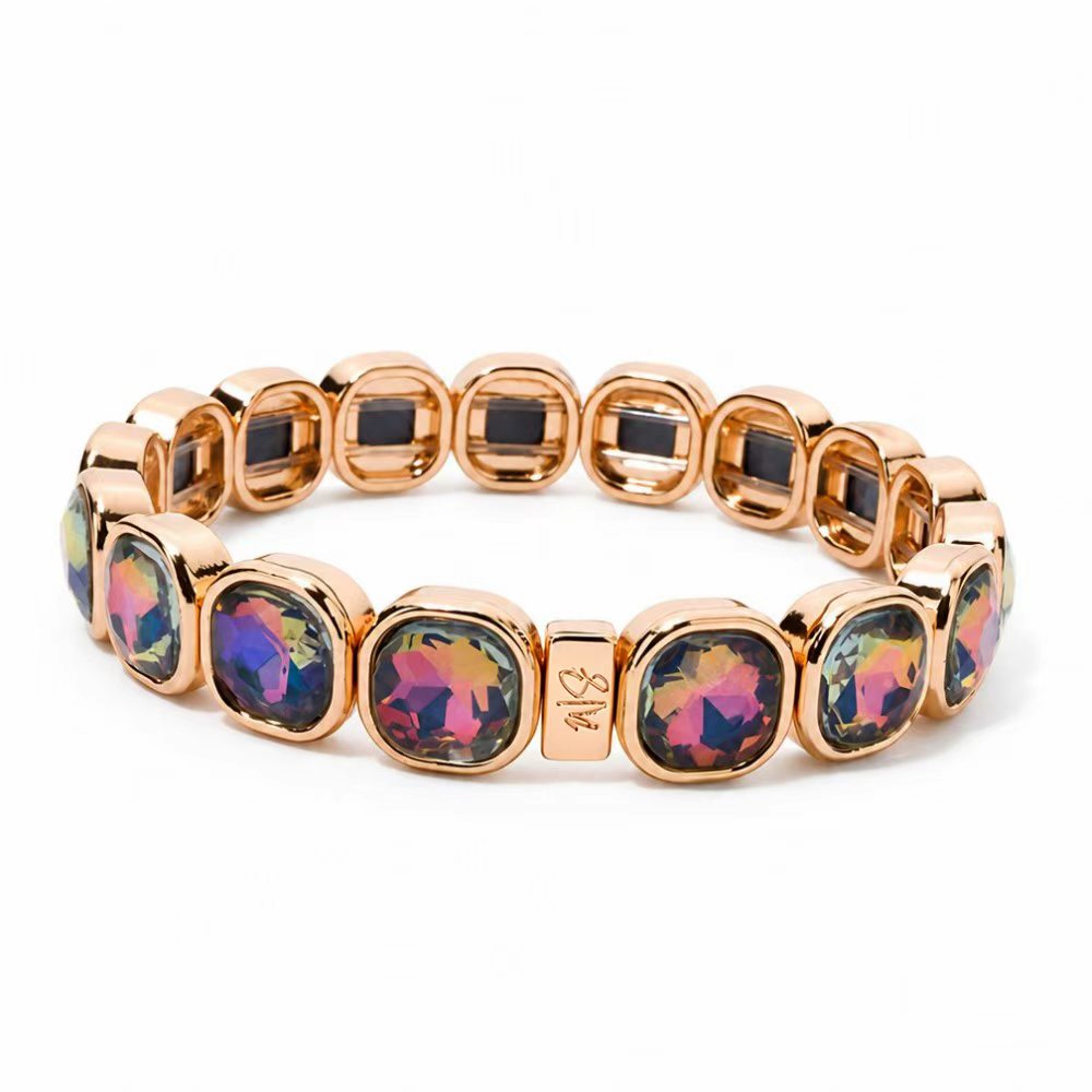 a gold bracelet with colorful stones