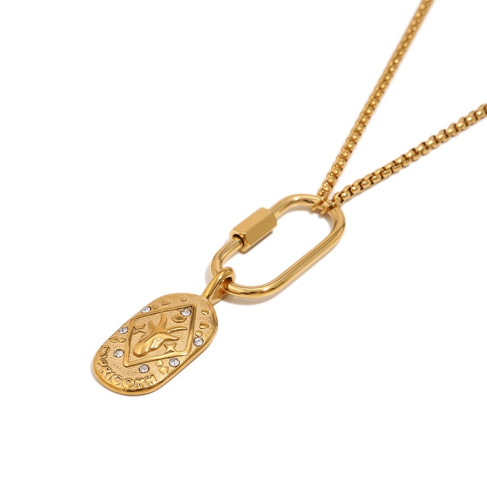 a gold necklace with a pendant