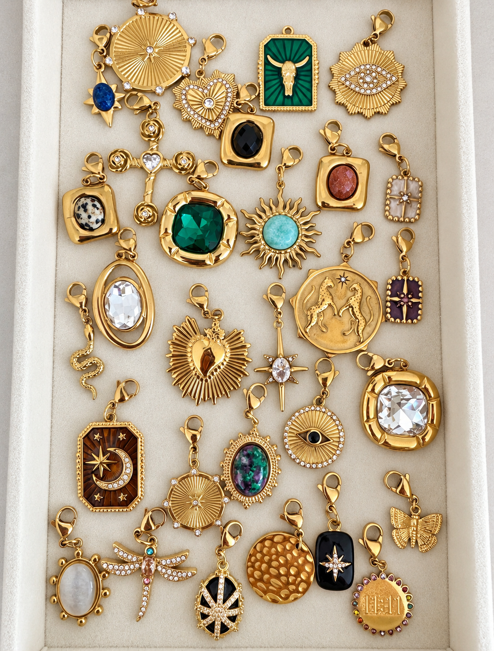 a group of gold jewelry in a box