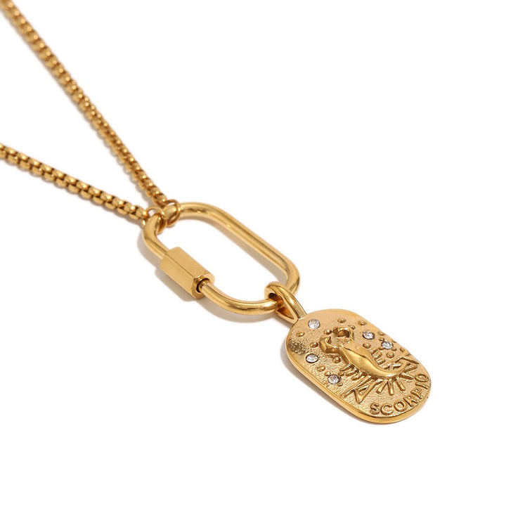 a gold necklace with a pendant