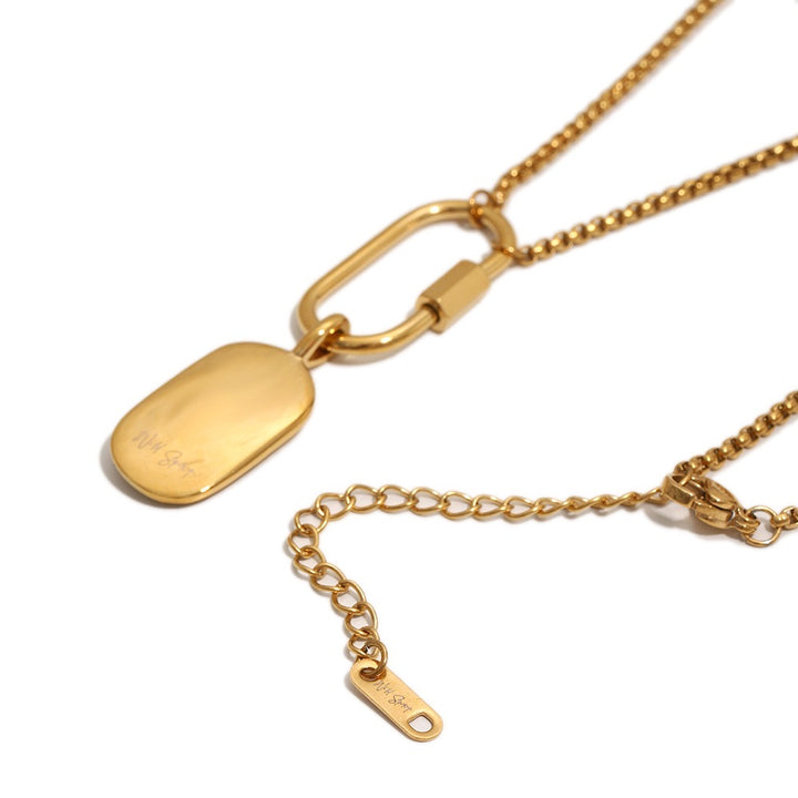 a gold necklace with a tag