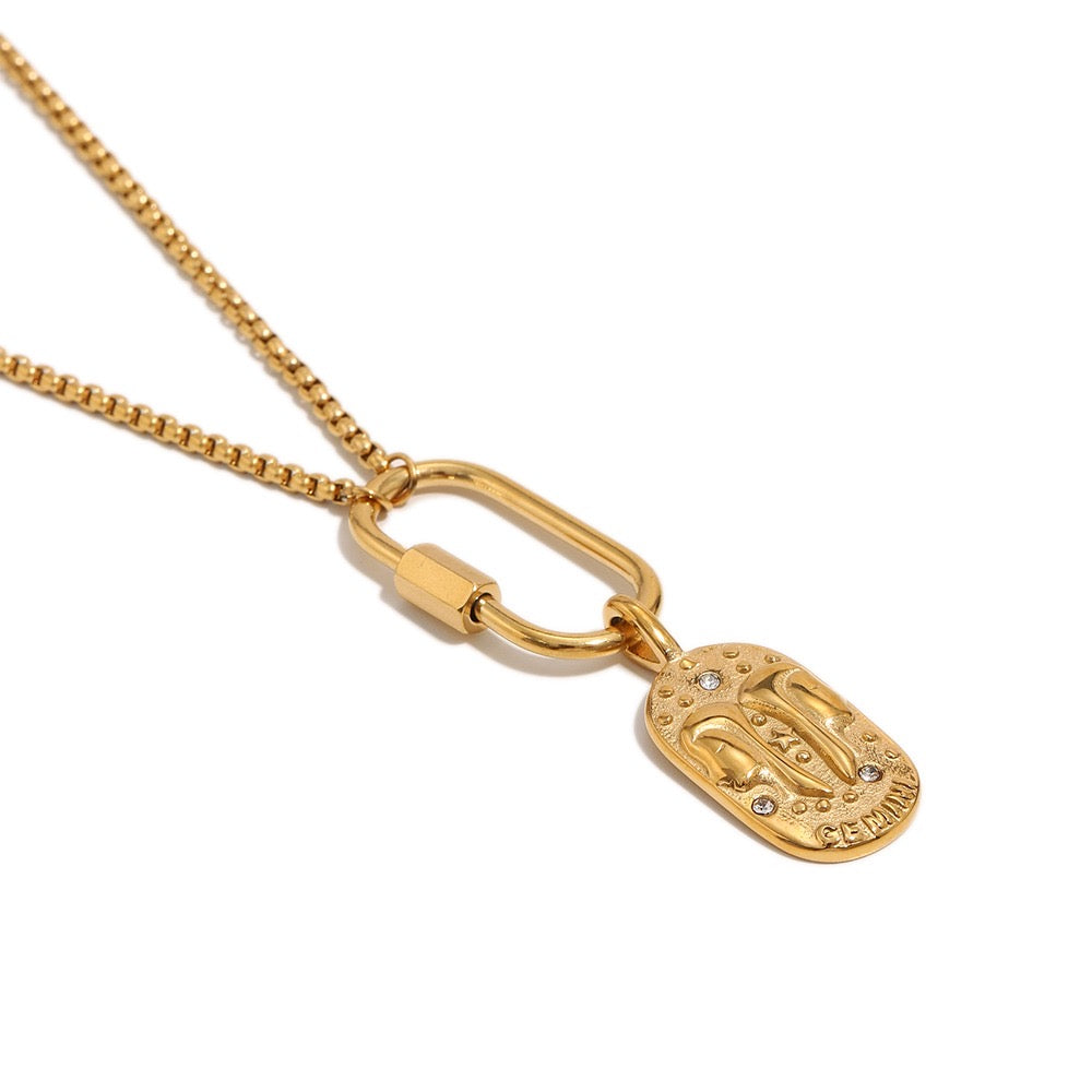 a gold necklace with a pendant