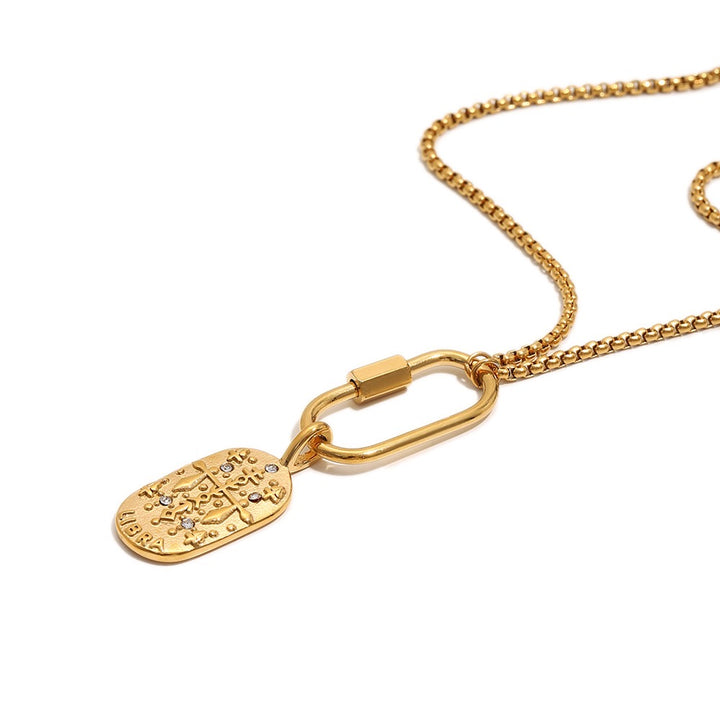 a gold chain with a oval shaped pendant