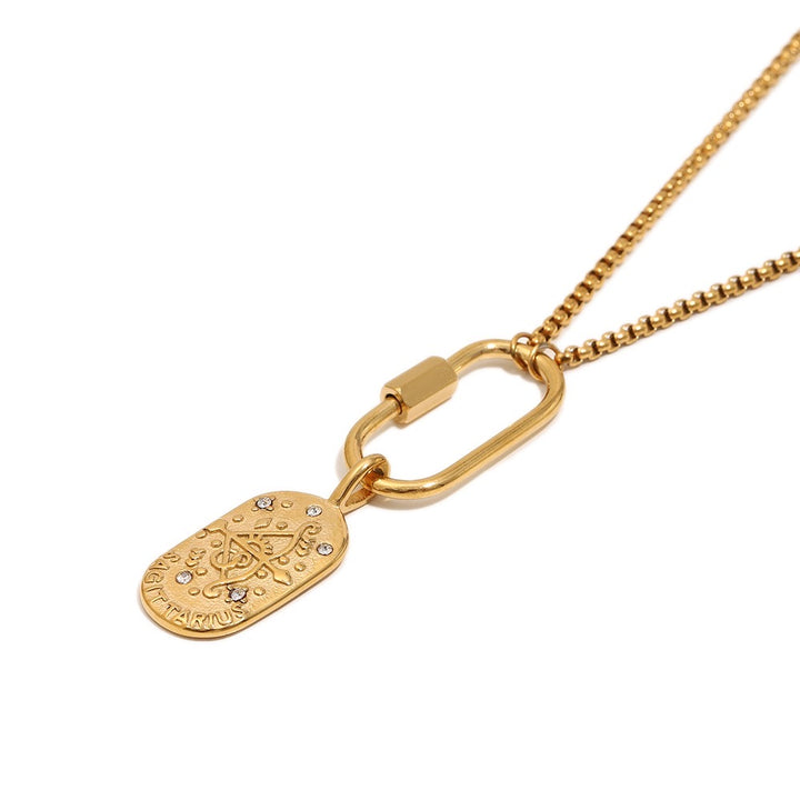 a gold necklace with a oval shaped object