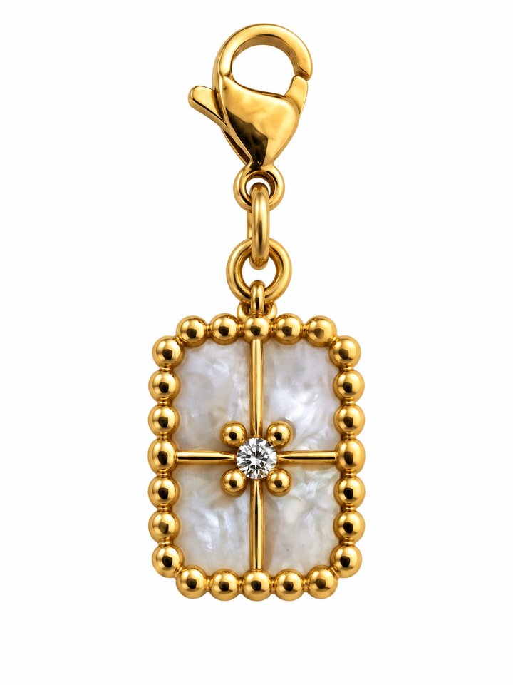 a gold pendant with a diamond