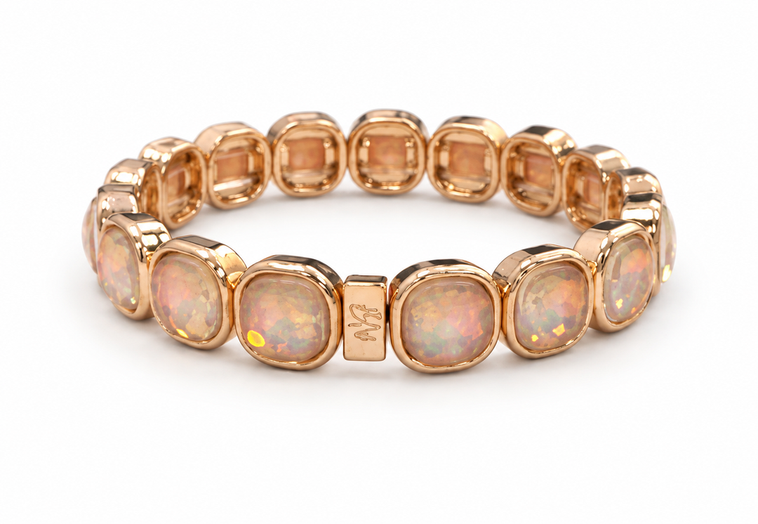 a gold bracelet with white stones