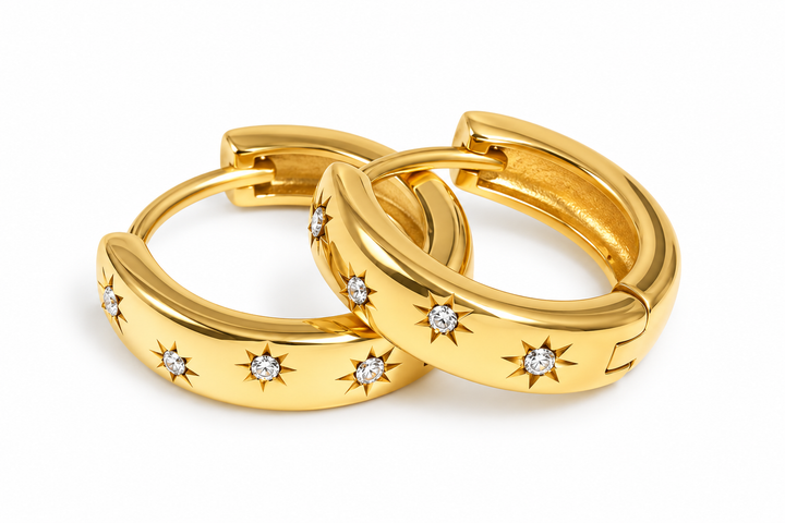 a pair of gold hoop earrings with diamonds