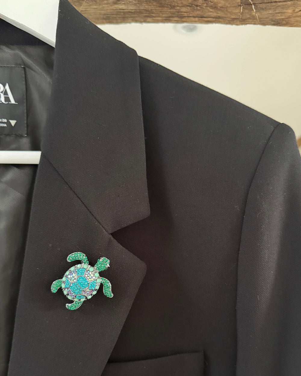 a turtle pin on a coat