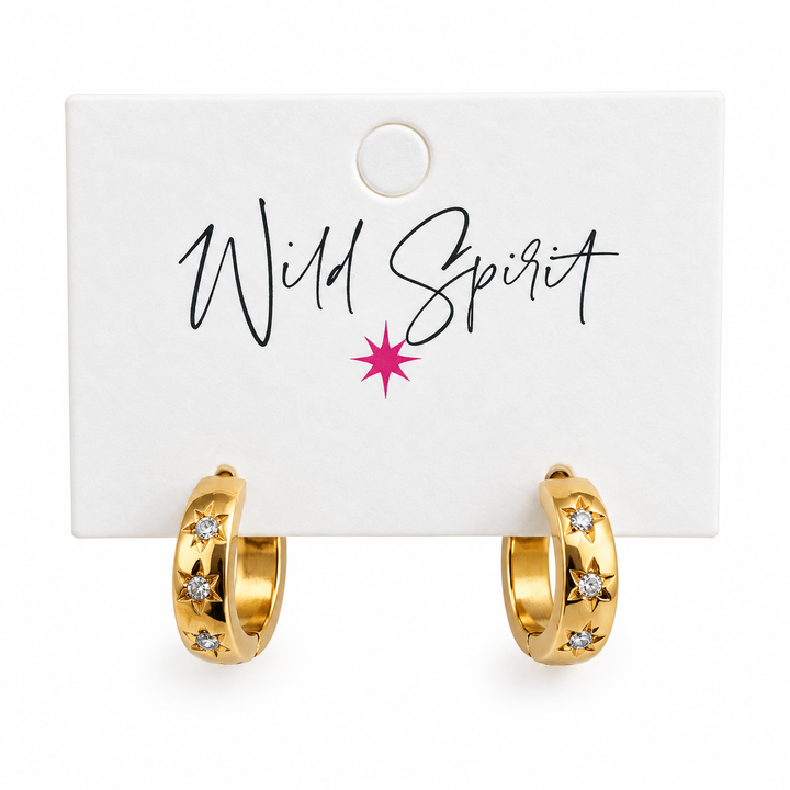 a pair of gold hoop earrings with diamonds on a white card