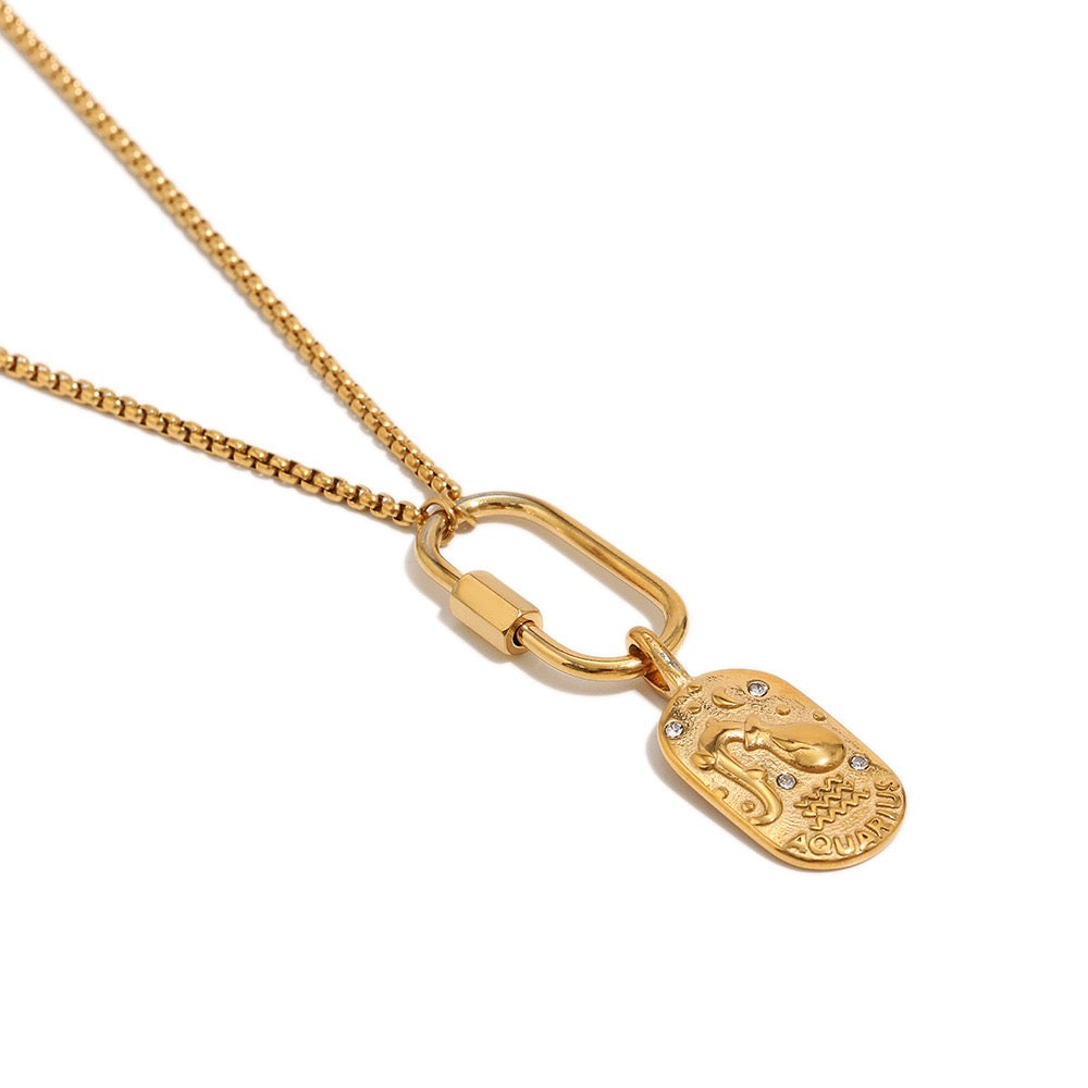 a gold necklace with a pendant