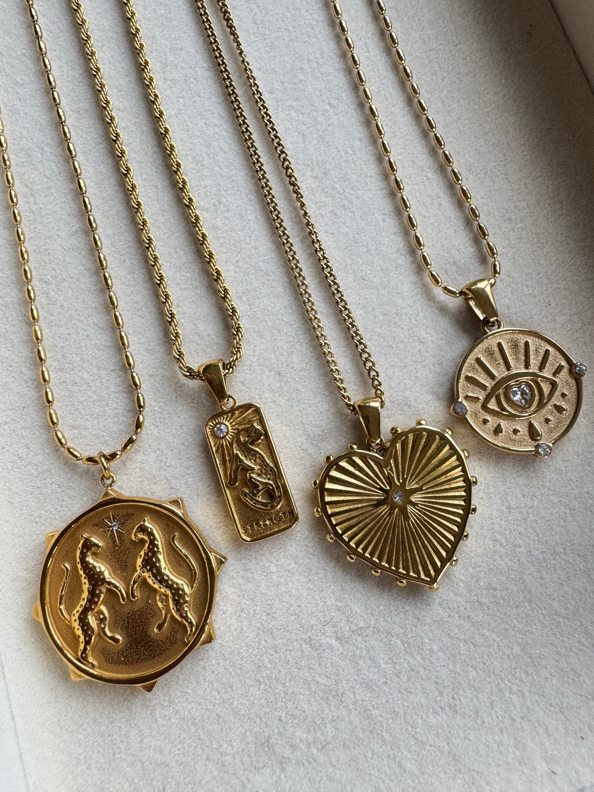 a group of gold necklaces